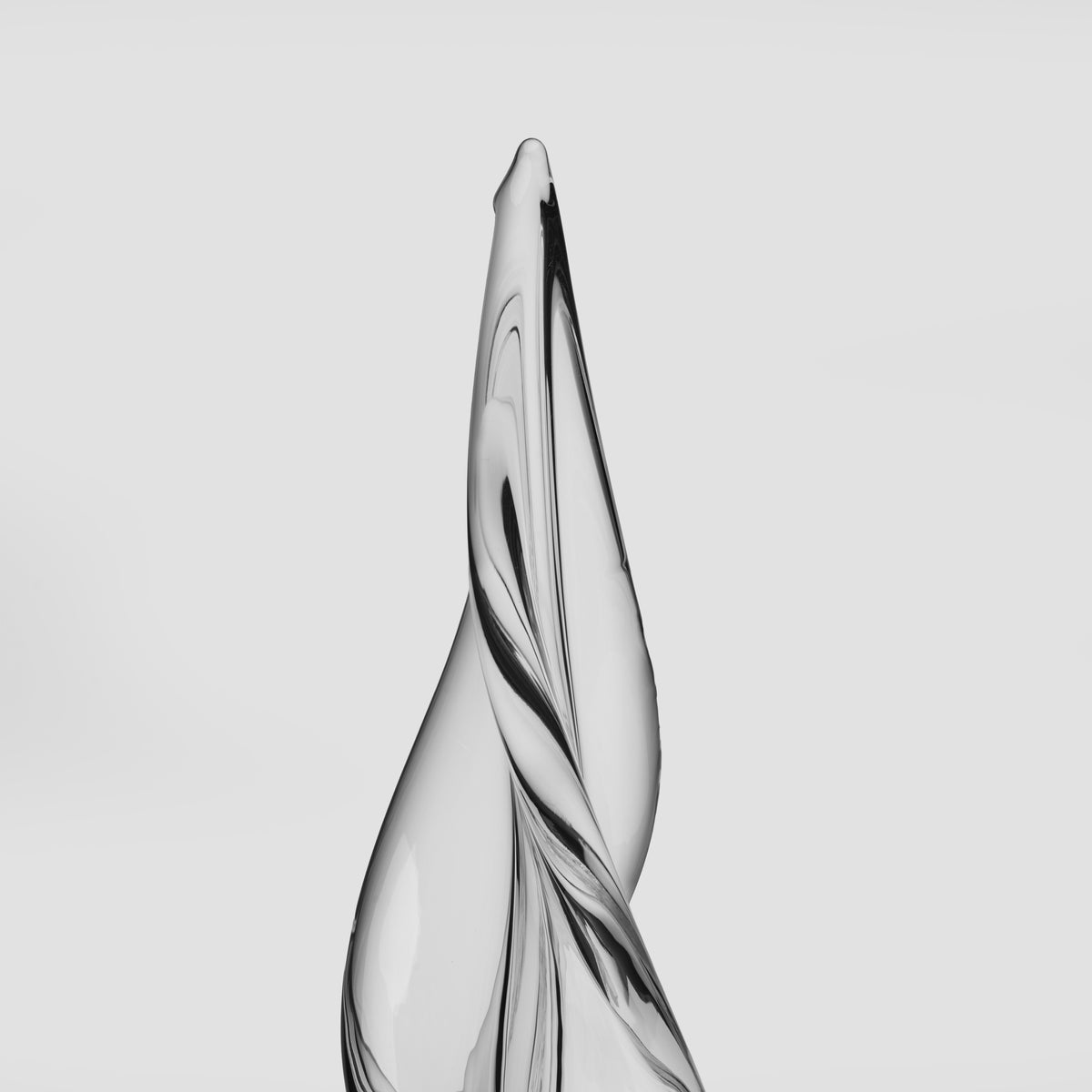 Tall spiral tree sculpture with three-sided twisted design in silver and black tones.