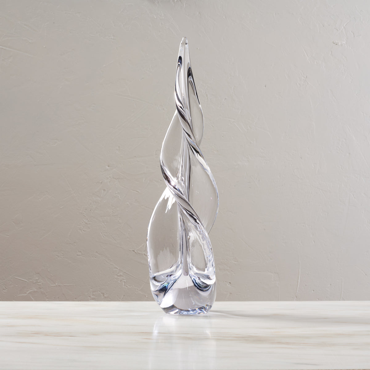 Clear glass spiral tree sculpture with three-sided twisted design and pointed top, approximately 20 inches tall.