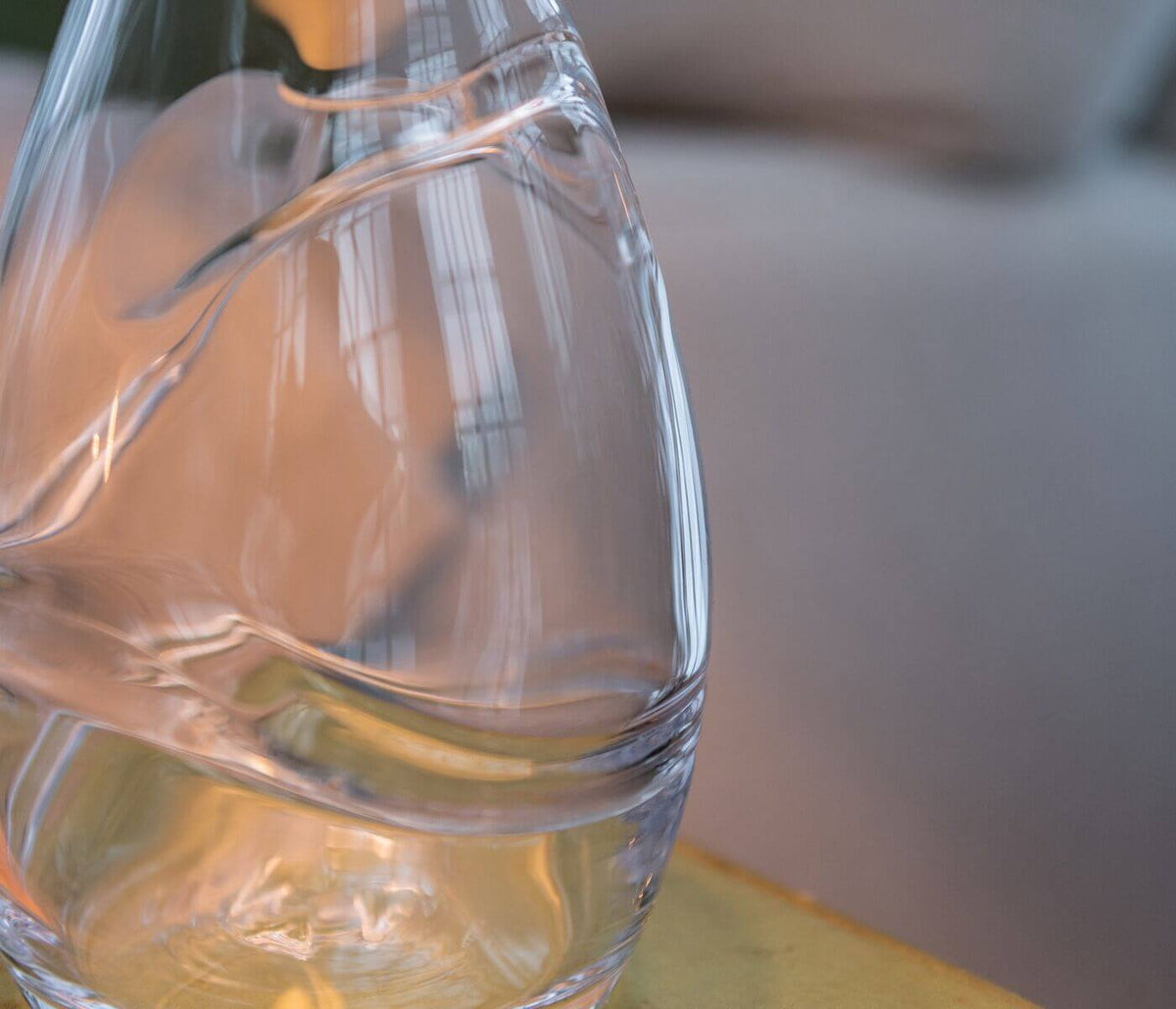 Clear glass lamp base with narrow cylindrical form and vertical ribbed texture detail.
