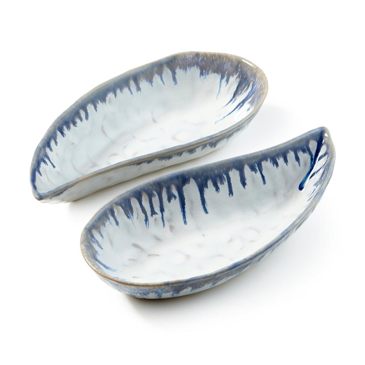 Two white ceramic mussel shell-shaped bowls with blue brushstroke detailing and tan rim edges.