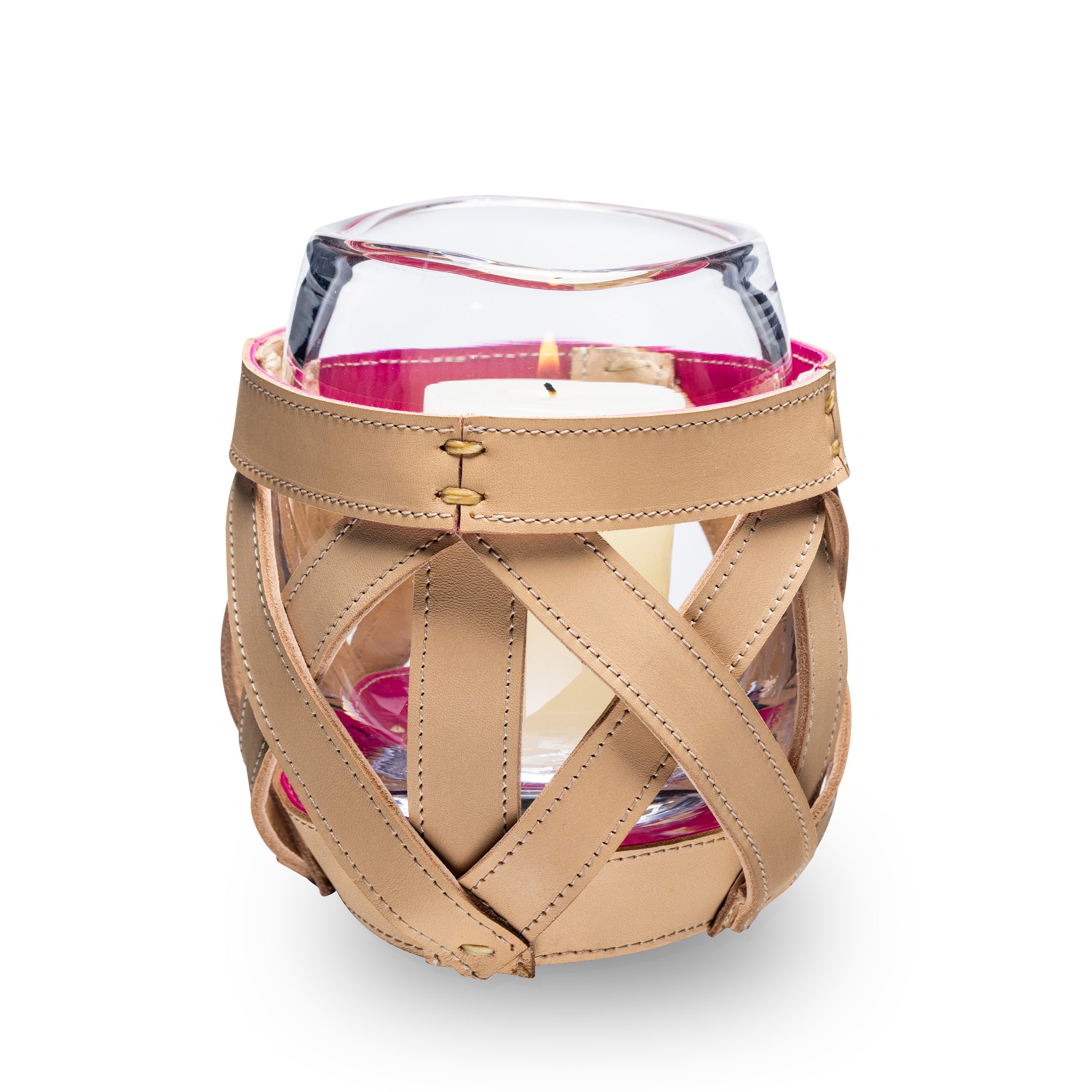 Tan leather wrap with cross-stitch pattern securing a glass hurricane candle holder with pink interior visible through cutout