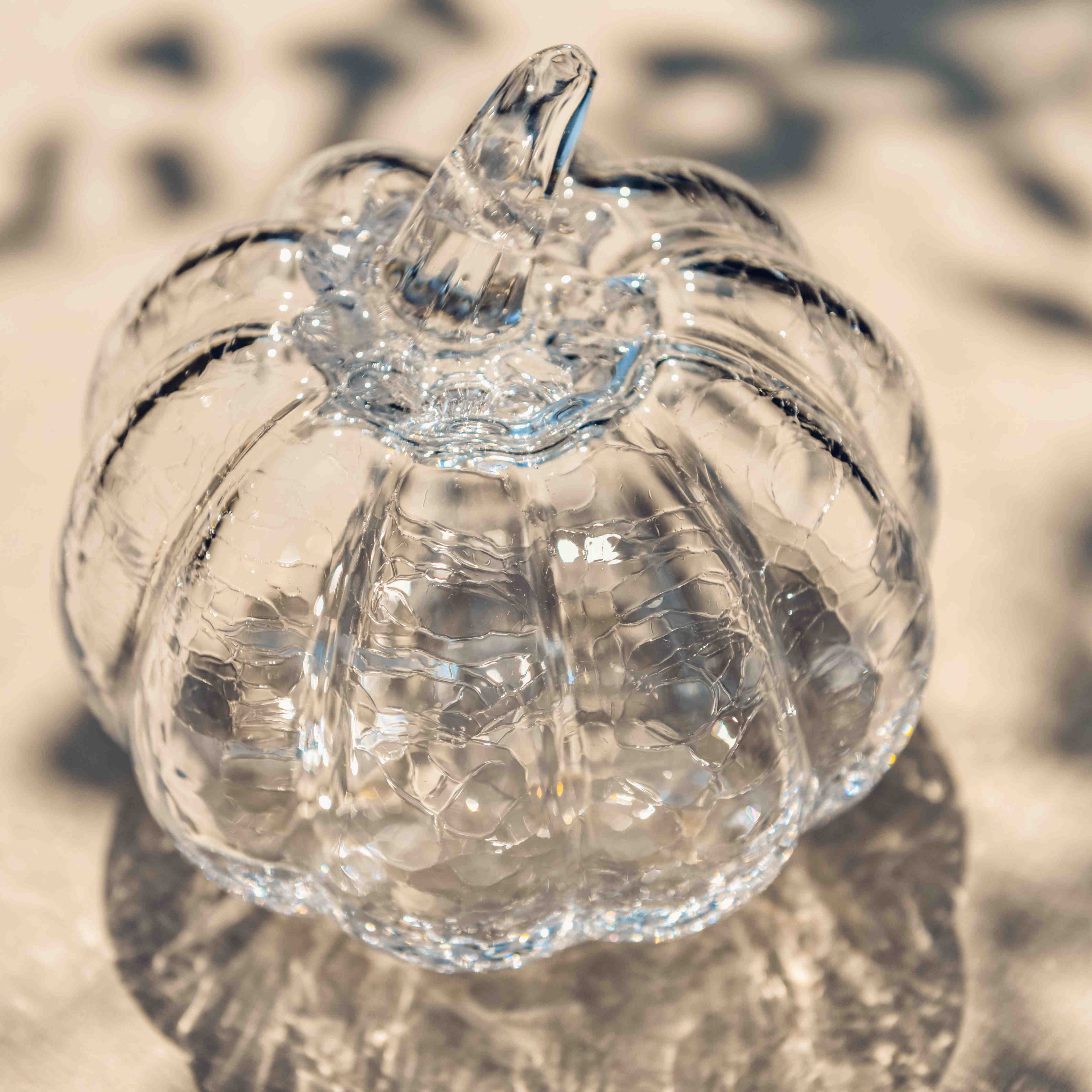Clear glass pumpkin with crackle texture and stem detail.