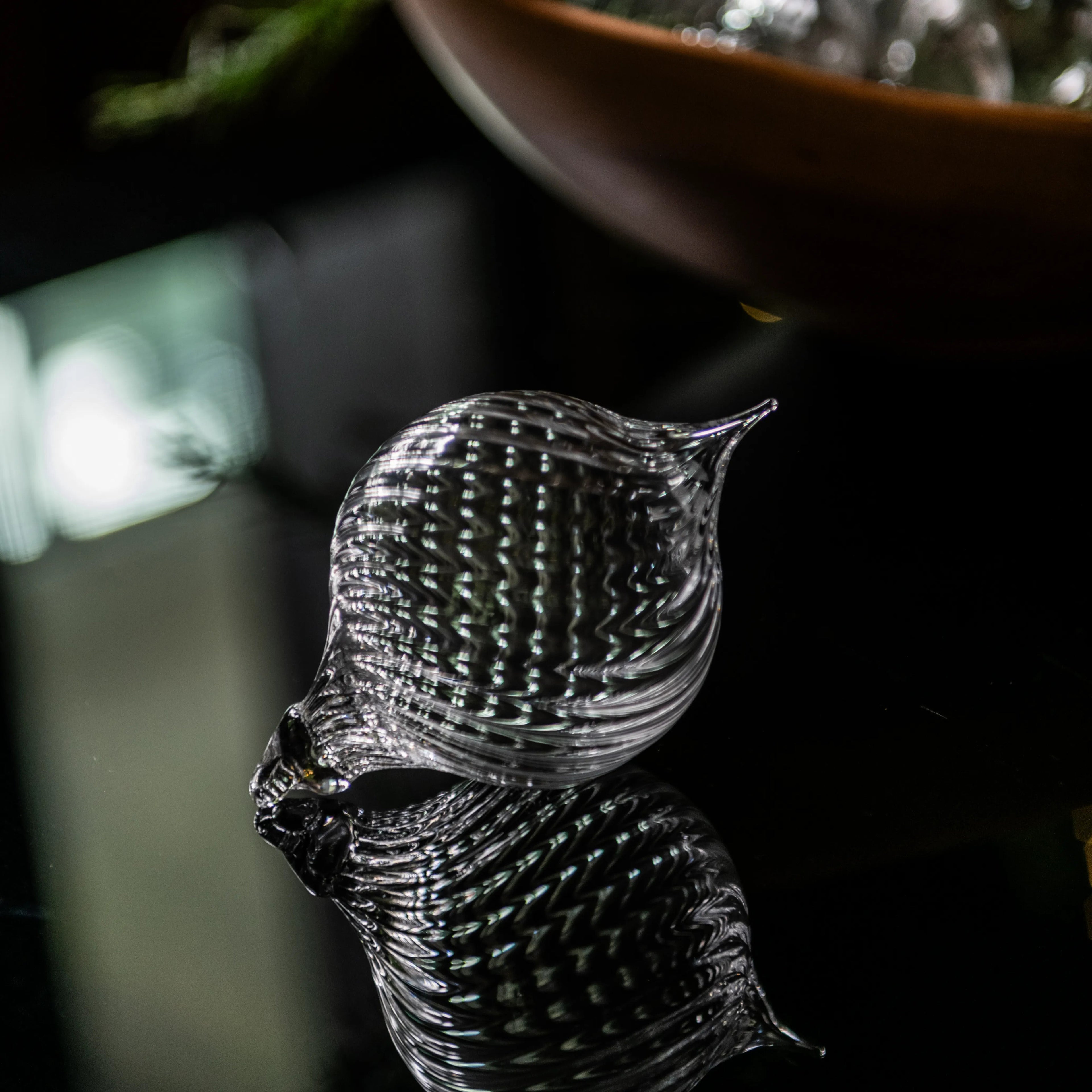 Clear glass finial ornament with textured optic pattern and pointed top.