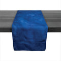 Deep indigo linen table runner with textured surface displayed on dark wood table.