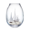 Clear glass globe vase with three etched sailboats and sand at the bottom.