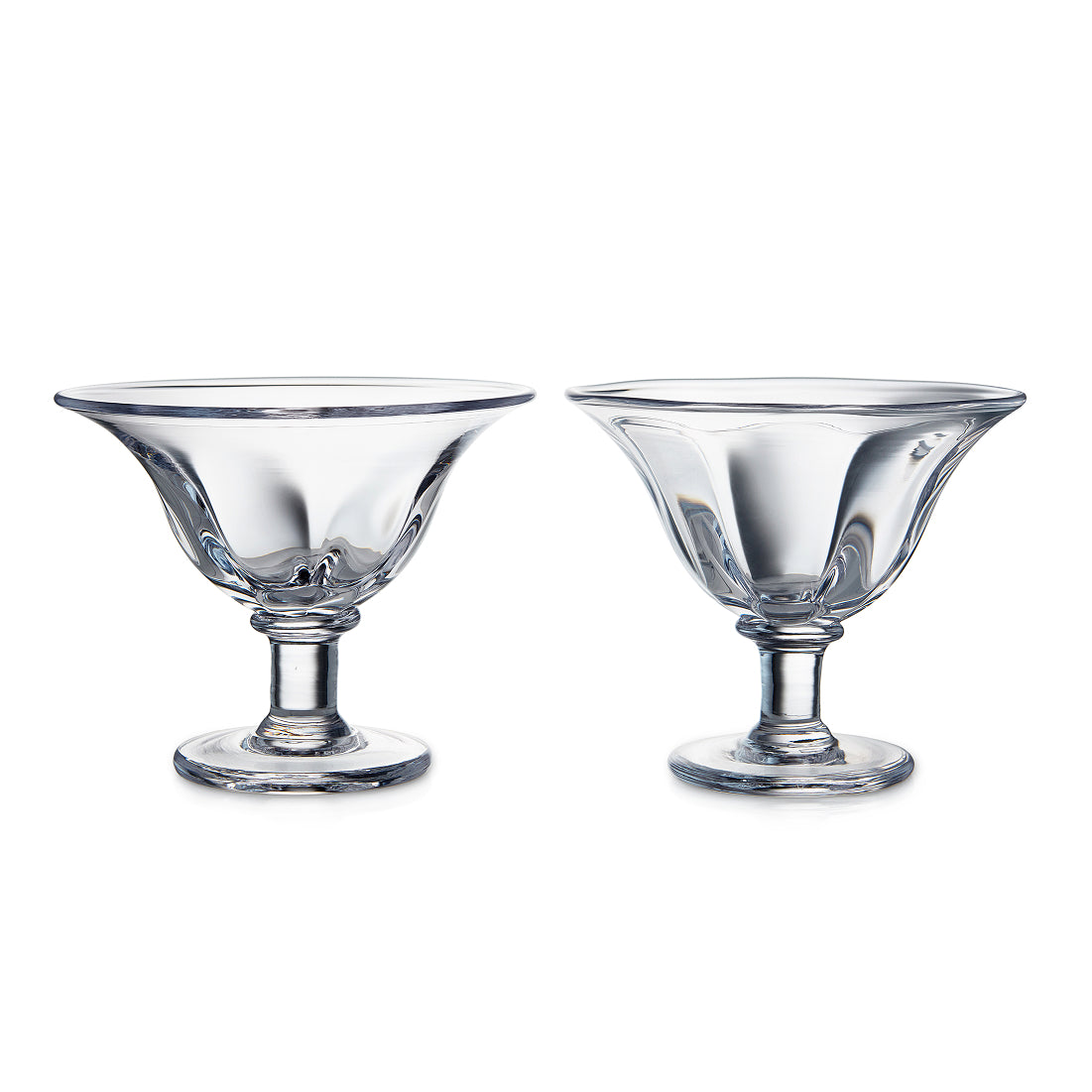 Two clear glass dessert bowls with pedestal bases and flared rims.