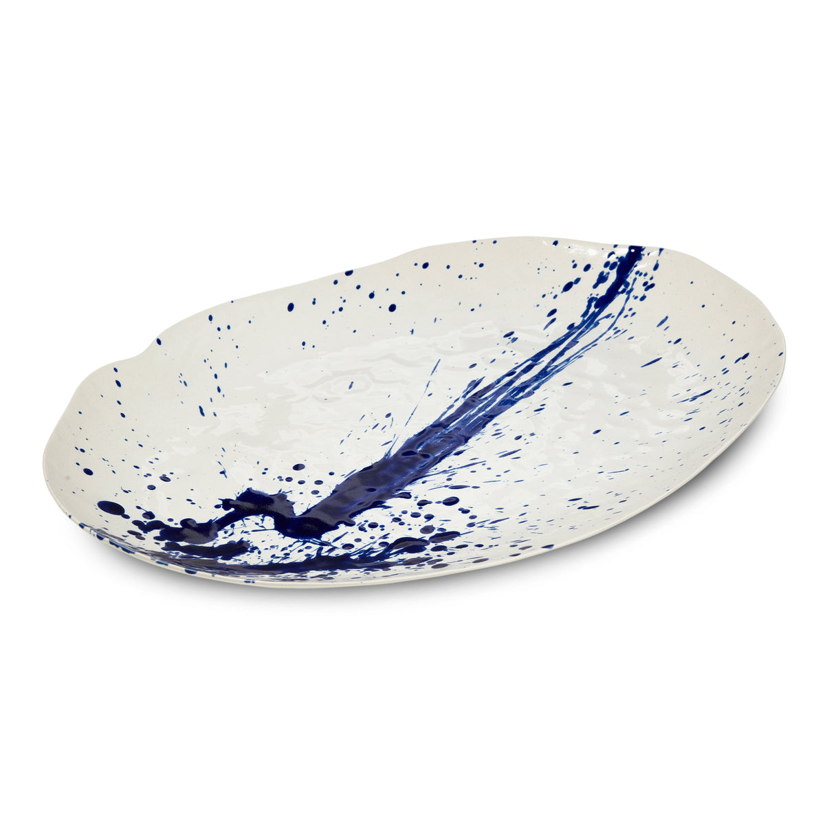 White oval ceramic platter with blue splatter and brushstroke design.