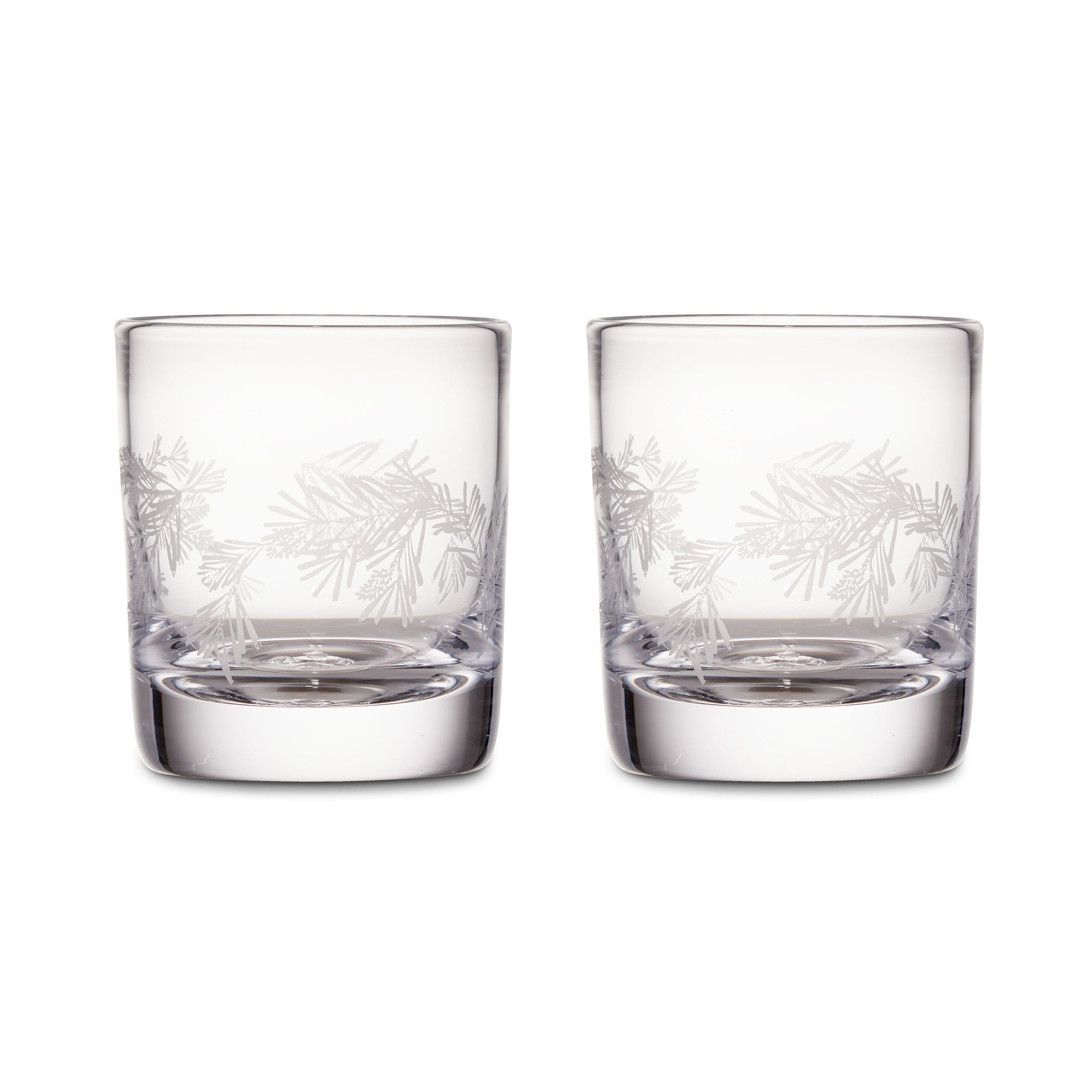 Two clear double old-fashioned glasses with engraved pine needle design around the upper portion.