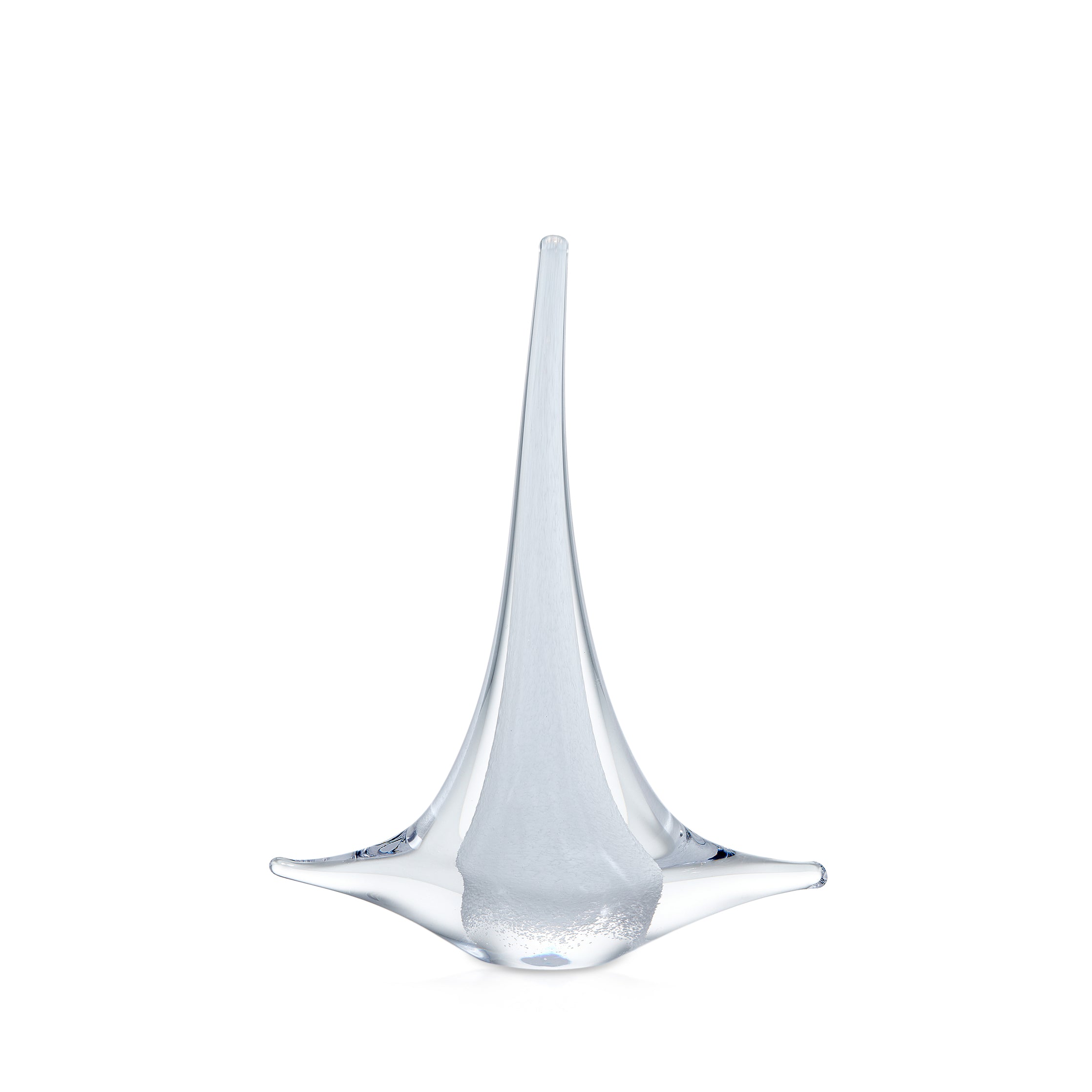 Clear glass sailboat figurine with tall mast and curved sail-like base on white background.