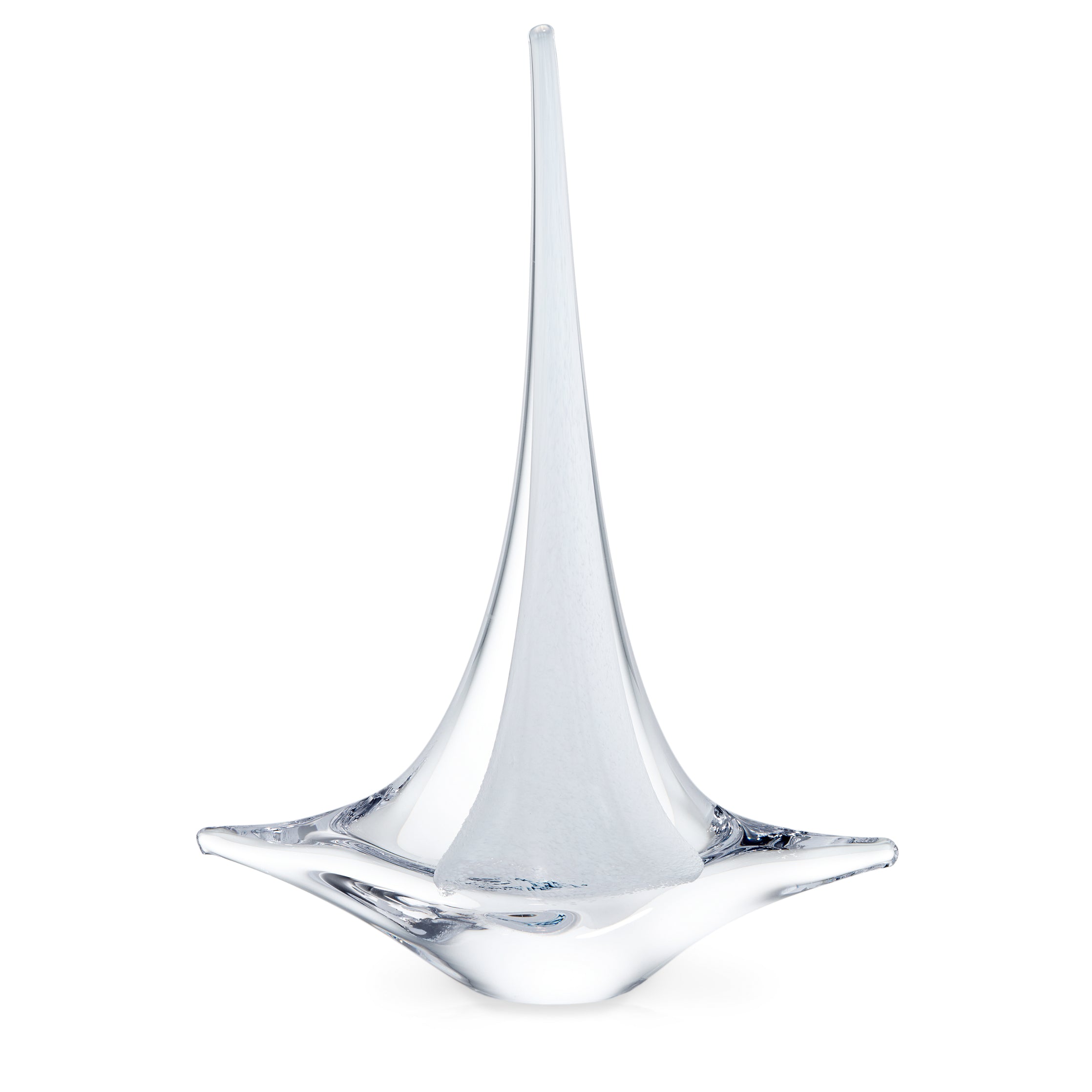 White glass sailboat with tall pointed sail and wide curved base.