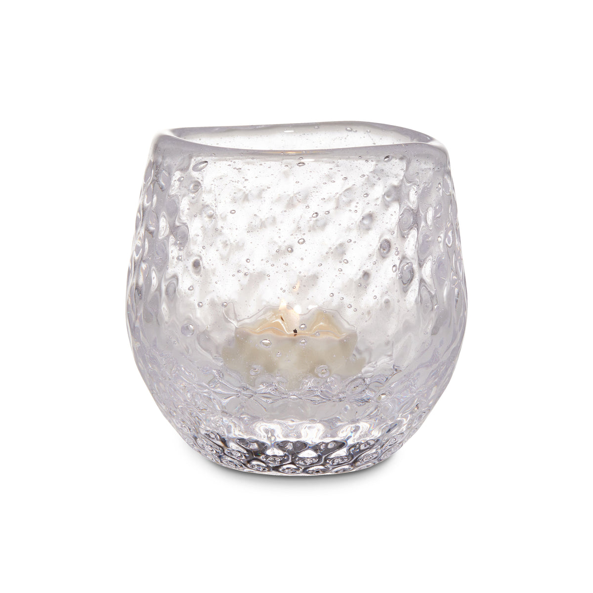 Clear glass tealight holder with textured bubble pattern containing a cream-colored tealight candle.