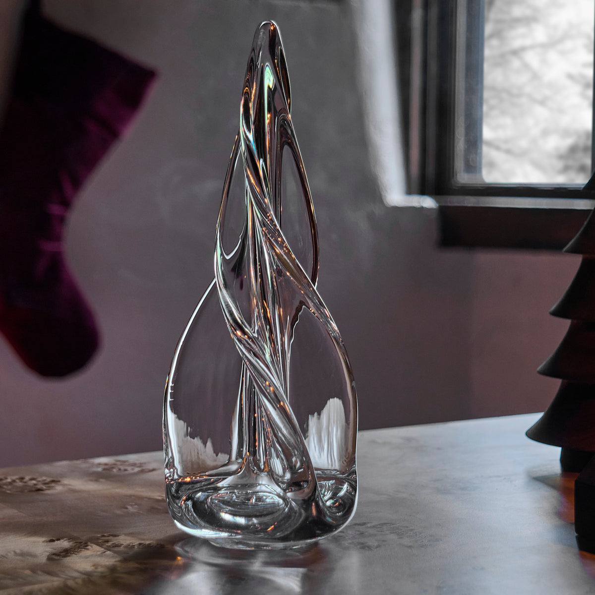 Clear glass decorative tree with spiral four-sided design and tapered point.