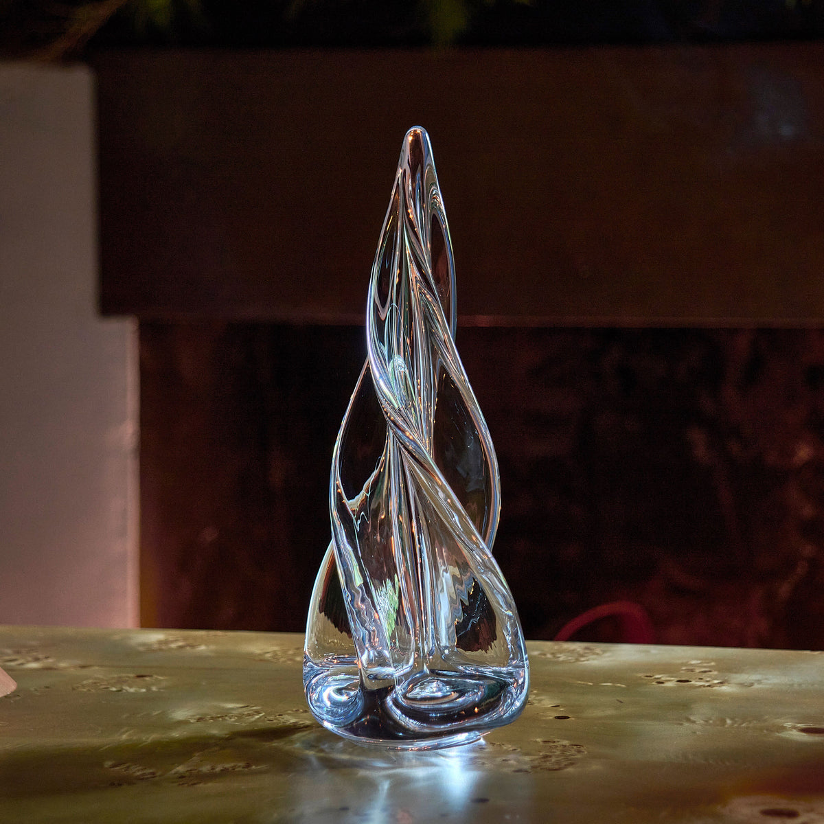 Clear glass spiral evergreen tree figurine with pointed top and four-sided base.