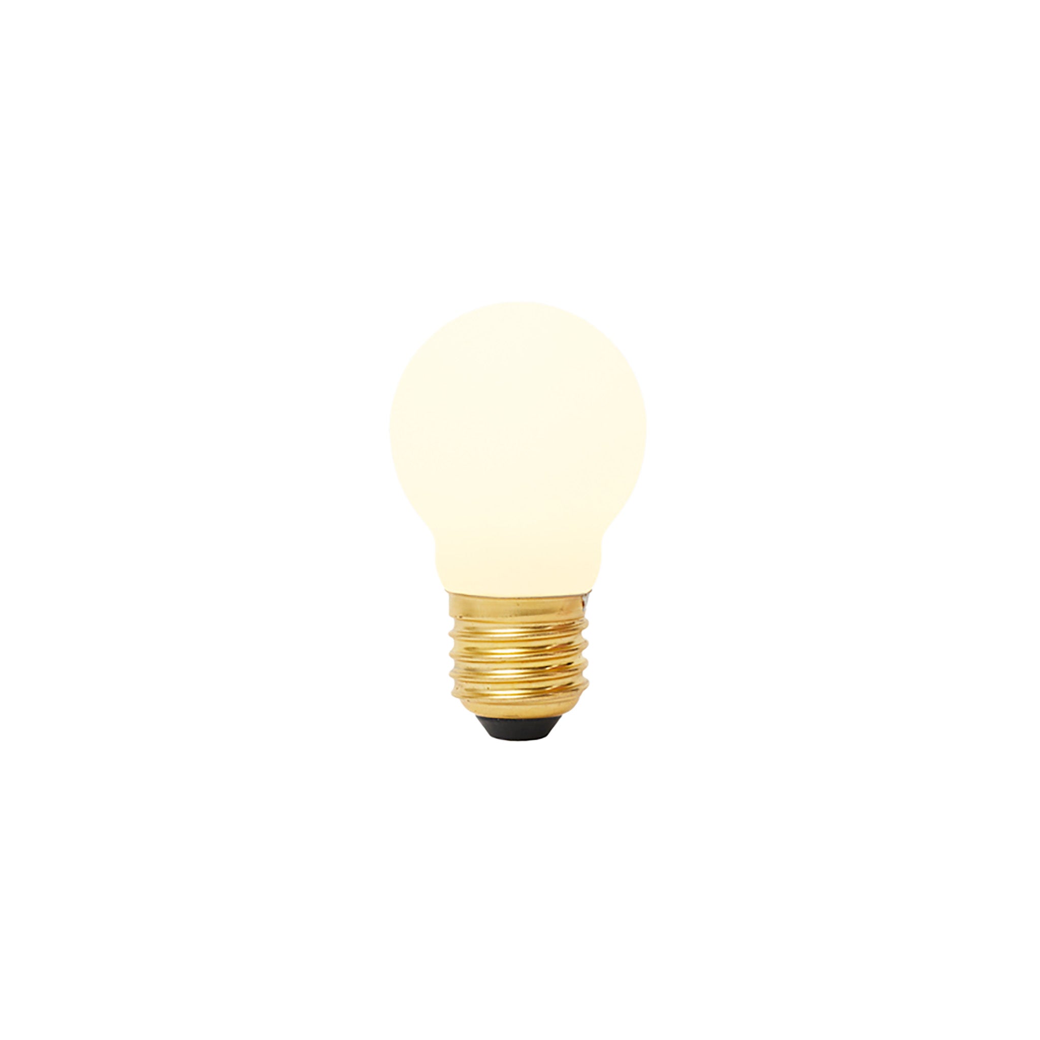 Matte porcelain spherical LED bulb with brass threaded base and black contact point, glowing warm white.
